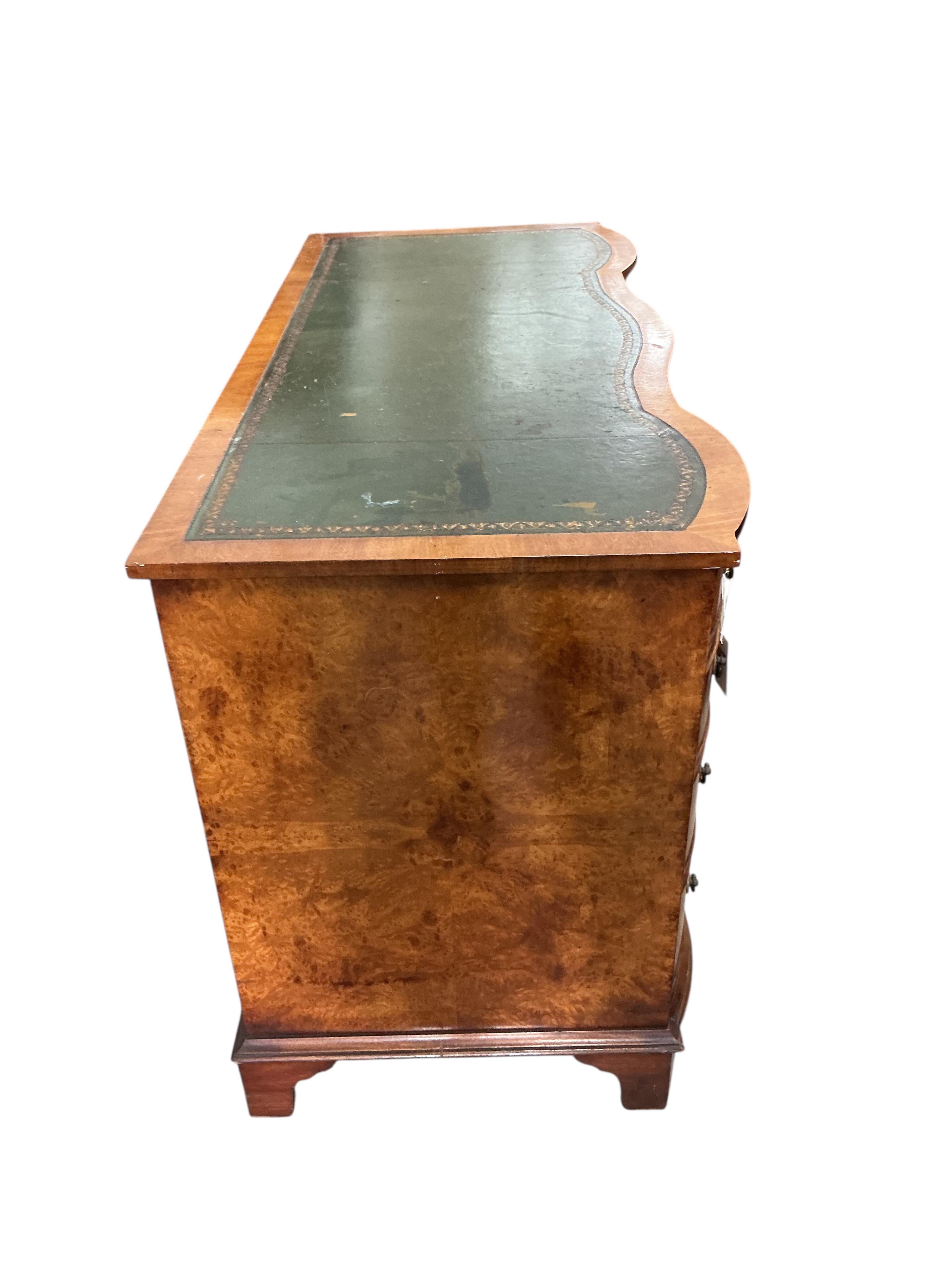 A reproduction burr walnut kneehole desk, width 115cm, depth 54cm, height 75cm